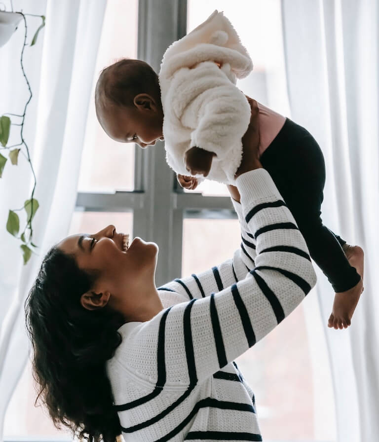 Happy mother playing with baby